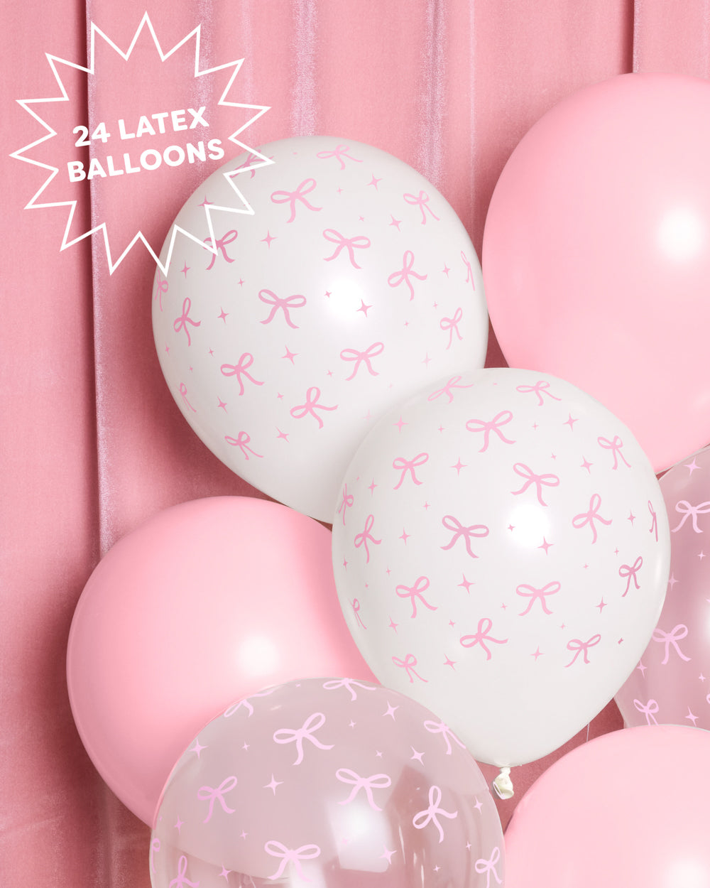 Close-up of white and pink latex balloons with a pink bow print