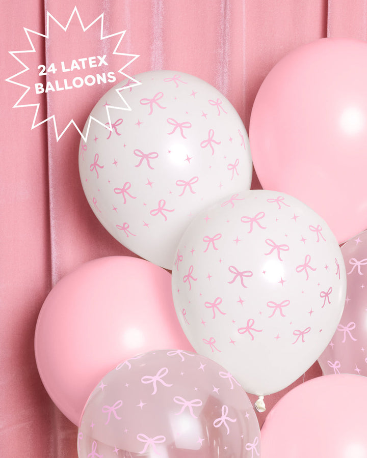 Close-up of white and pink latex balloons with a pink bow print