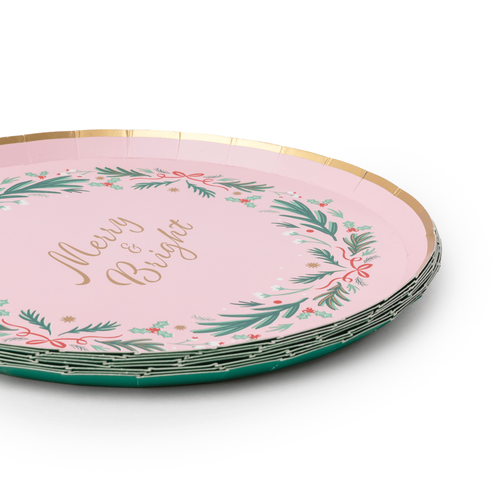 Stack of pink Christmas wreath plates showing the wreath rim design