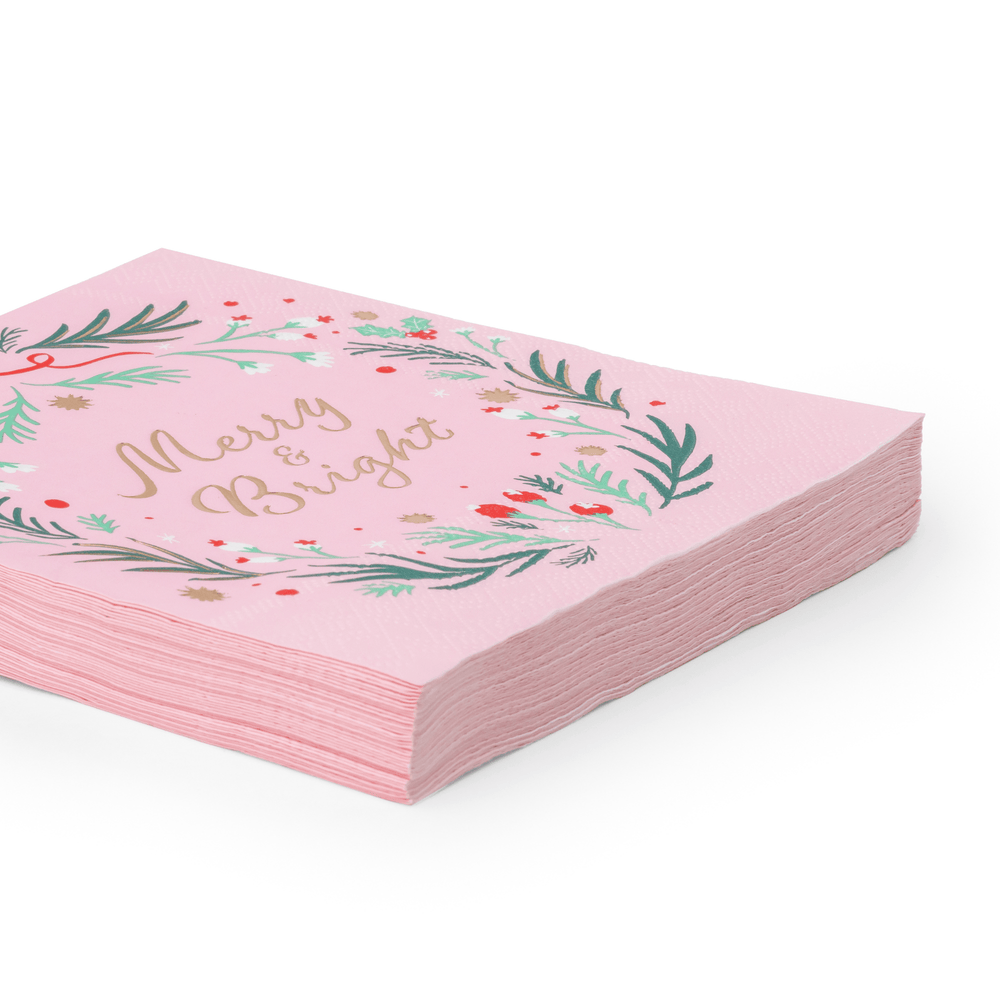 Stack of pink Christmas wreath napkins showing the folded wreath print