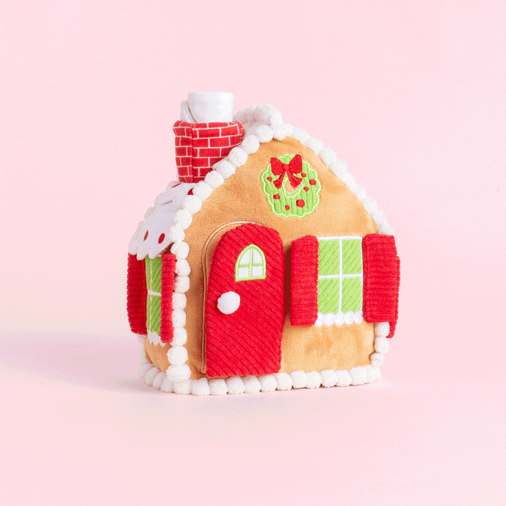 Animated clip of the gingerbread house dog toy on a pink backdrop