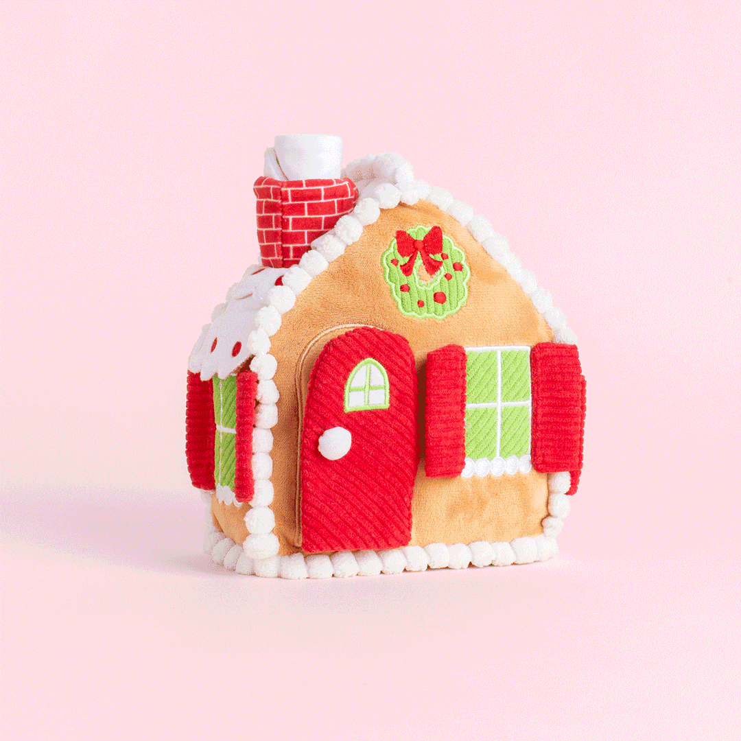 Animated clip of the gingerbread house dog toy on a pink backdrop