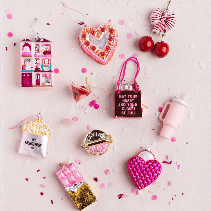 Pink glass ornaments including French fries, a martini, a heart cake, and a tumbler for a Christmas tree