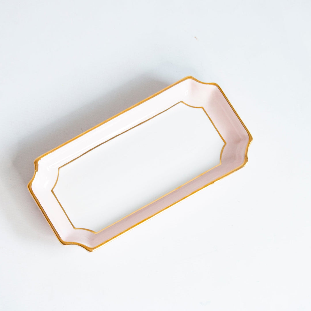 Pale pink two tone petite valet tray with a gold rim at an angle, a soft and pretty baby shower gift