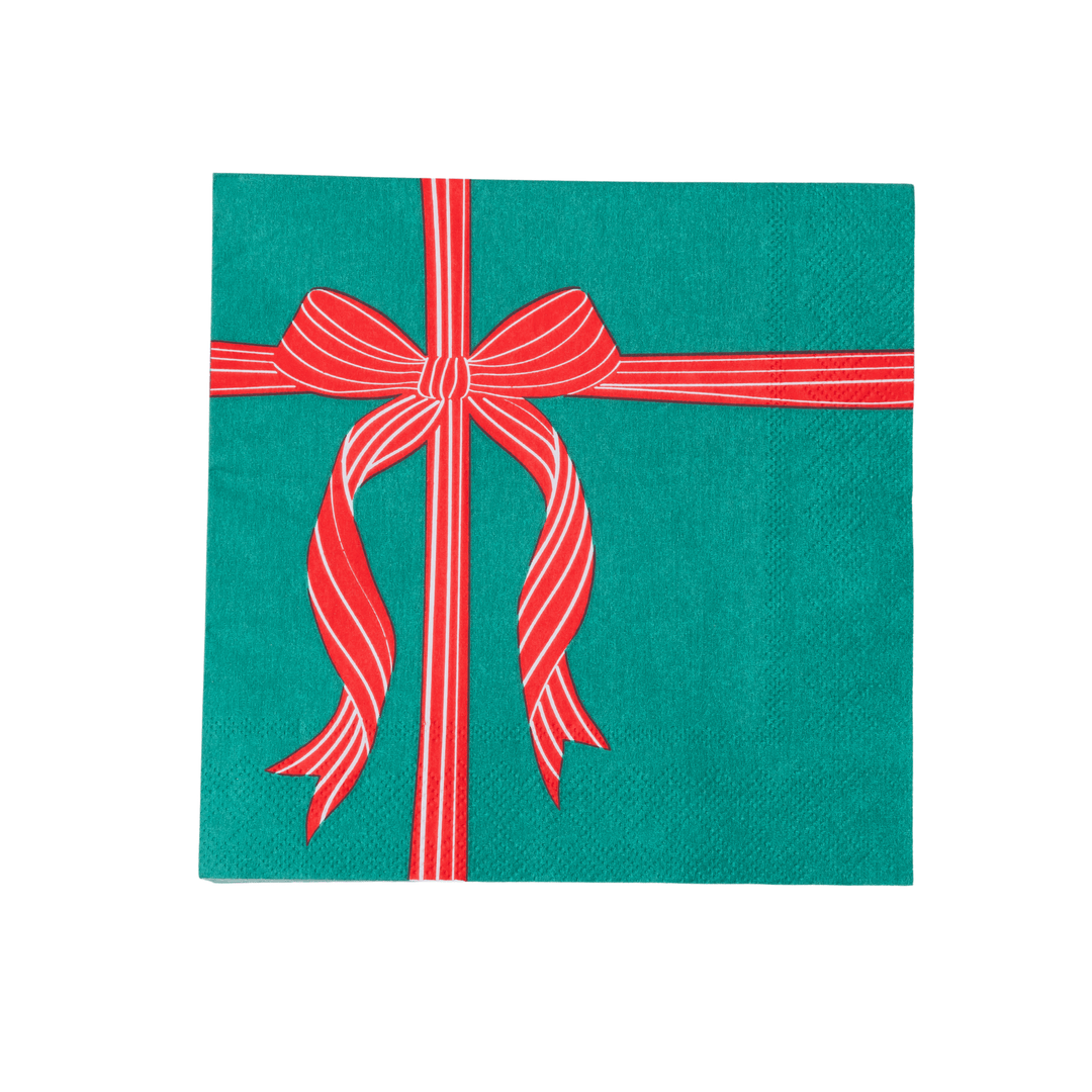 Stack of red and green present Christmas napkins showing the folded print edges