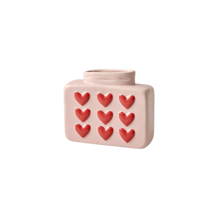 Pale pink rectangular ceramic vase with rounded corners, a narrow oval opening, and nine raised red hearts