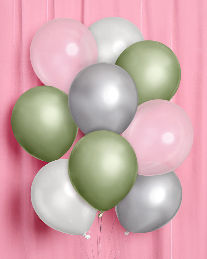 Bunch of sage green, silver chrome, white, and clear latex balloons on a pink backdrop