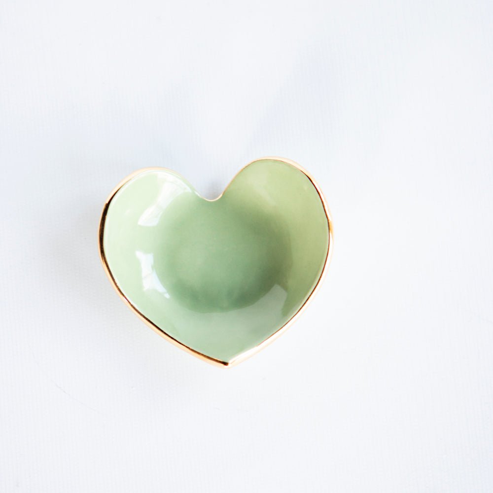 Second view of the sage green heart dish with its gold rim, angled