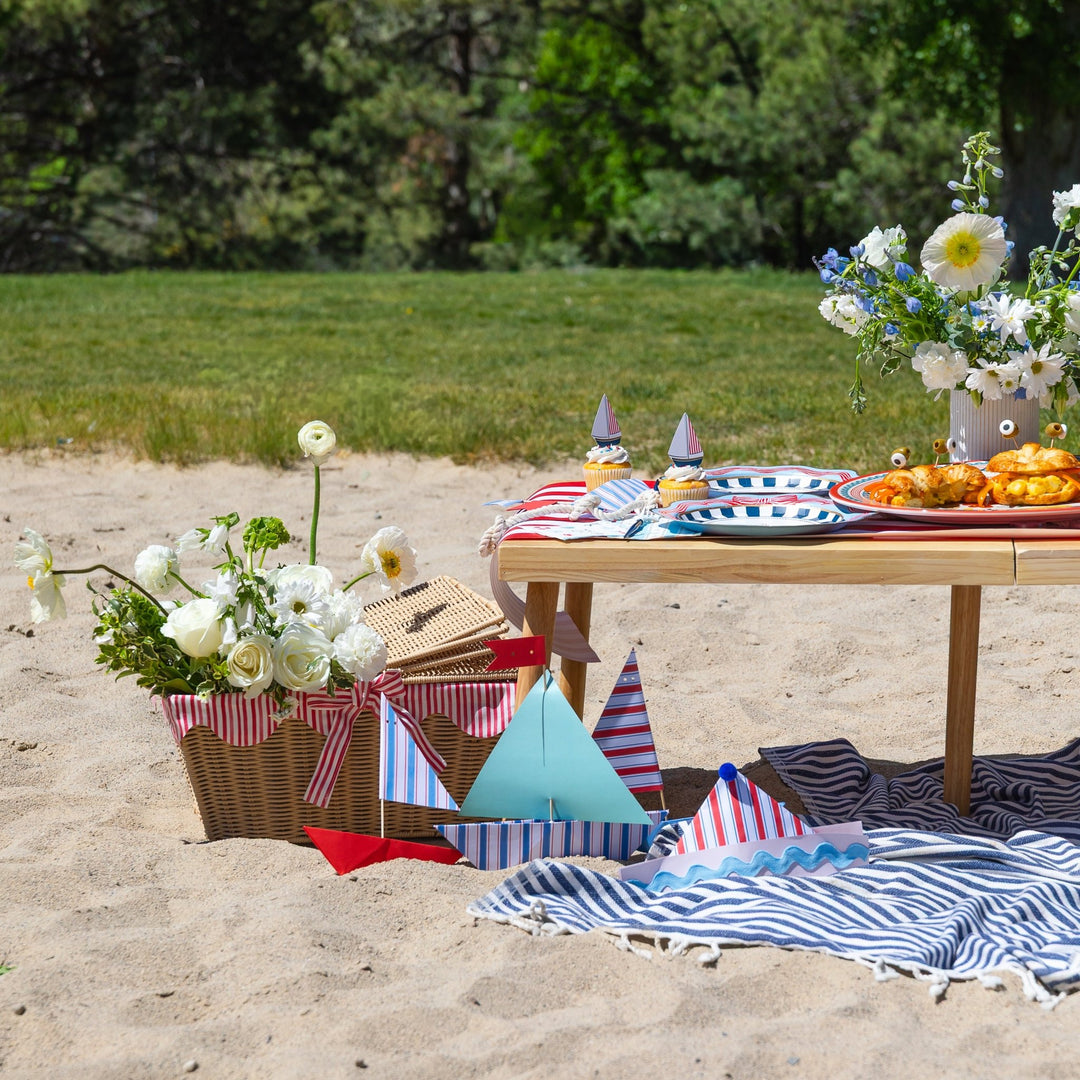 Sailor party hats worn at a Bonjour Fete summer sailing party with nautical and patriotic picnic decor