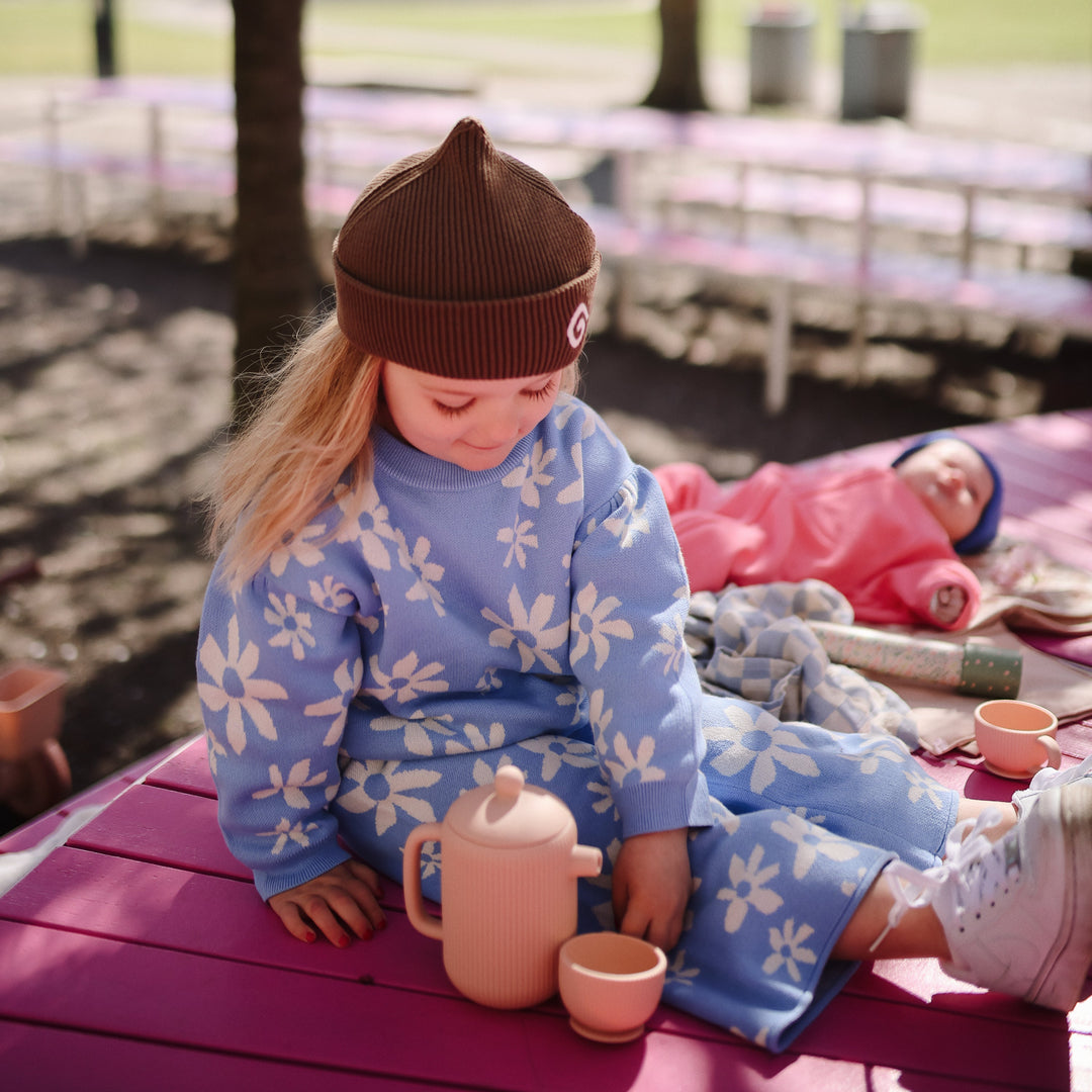 Child playing tea party with the Mushie silicone tea set