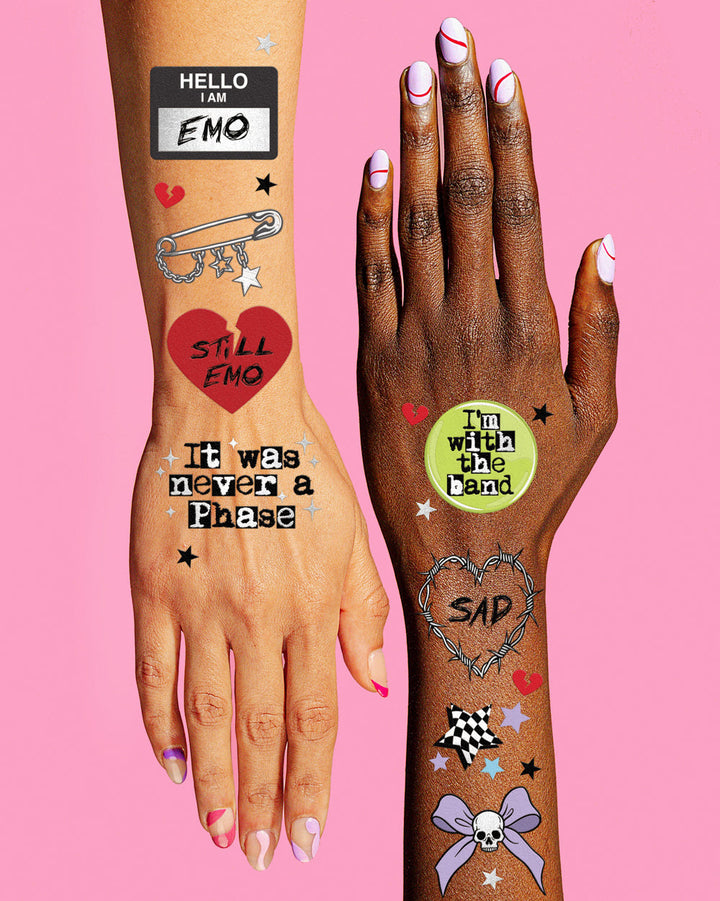 Emo tattoos with a red broken heart, name tag, and smiley worn on a forearm and hand