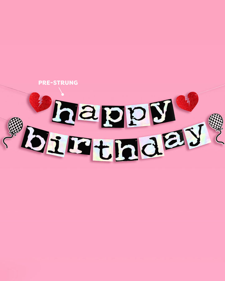 Pre-strung emo Happy Birthday banner with red glitter broken hearts and checkered balloon icons on a pink wall