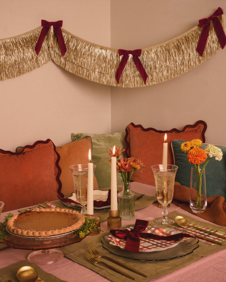 Gold Fringe Backdrop with Burgundy Velvet Bows
