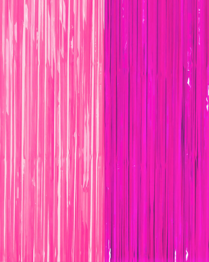 Bright pink and magenta fringe strands layered on a neon party curtain