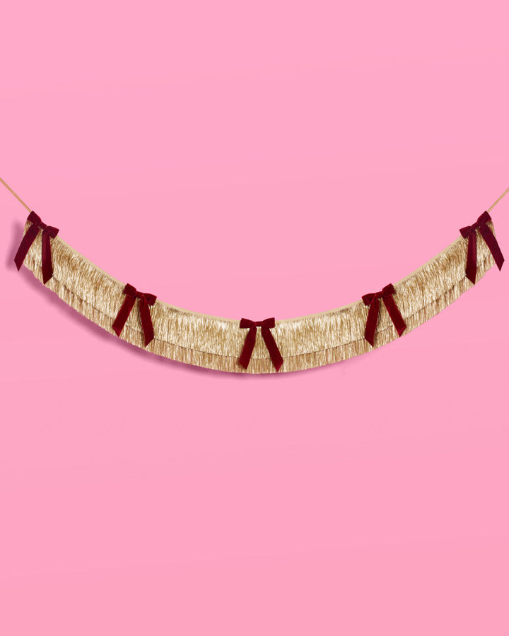 Gold Fringe Backdrop with Burgundy Velvet Bows