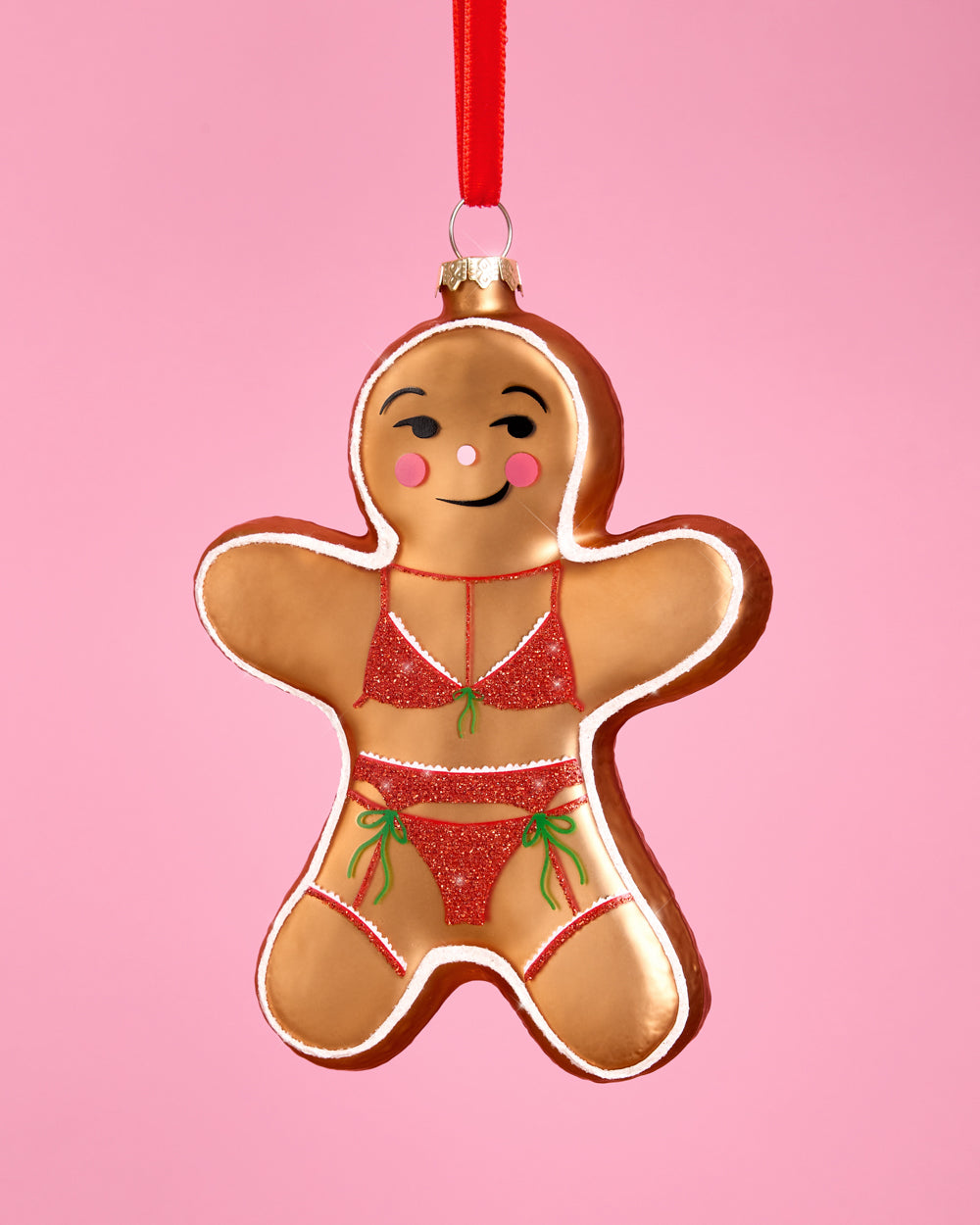 Another view of the gingerbread girl ornament, with its winking face and pink cheeks.