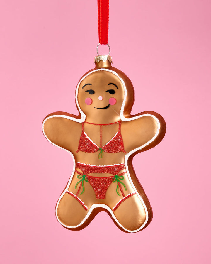 Another view of the gingerbread girl ornament, with its winking face and pink cheeks.