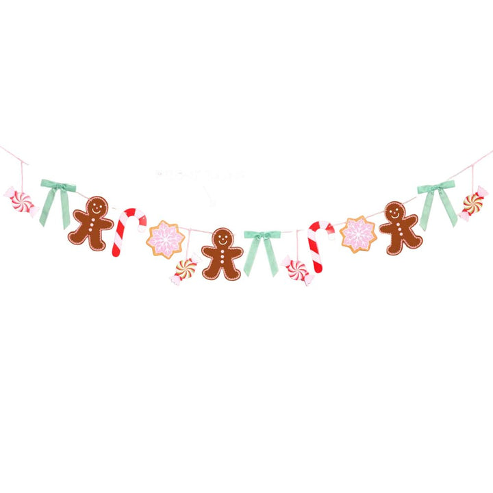 Pink gingerbread Christmas garland with cookie, candy cane, and snowflake icons