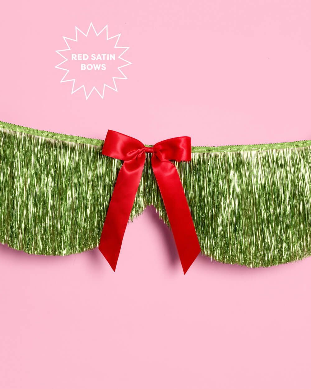 Close view of a red satin bow on the lime green scallop fringe