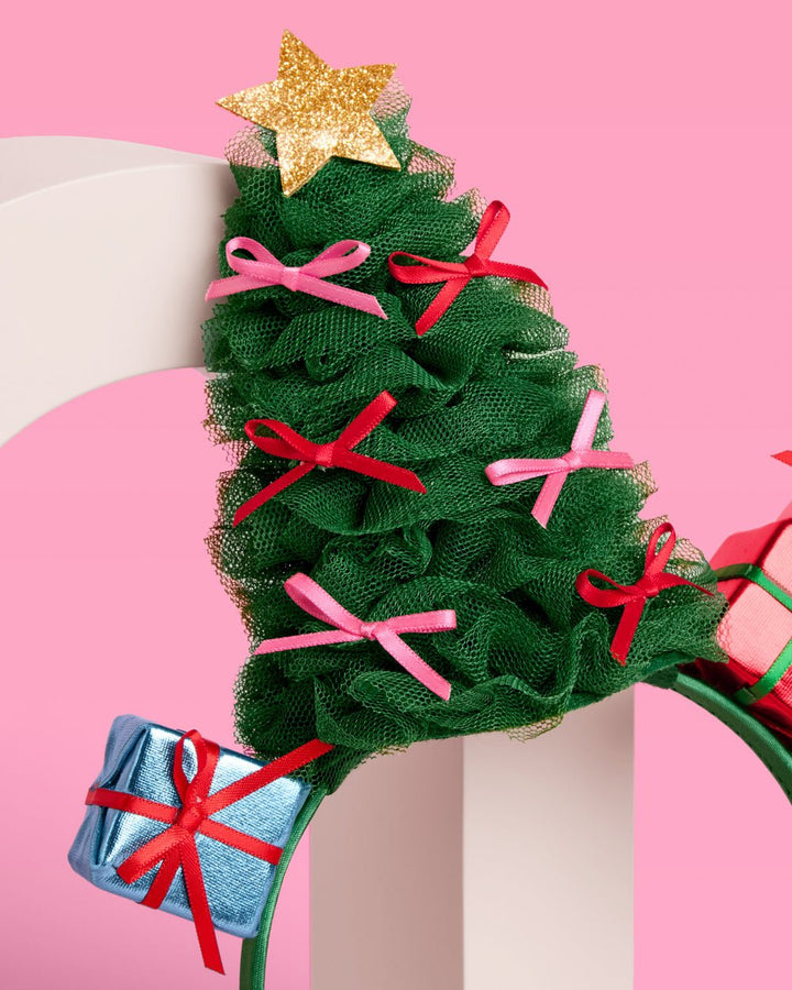 Close-up of the ruffled green tulle tree with pink and red bows and a gold glitter star on top