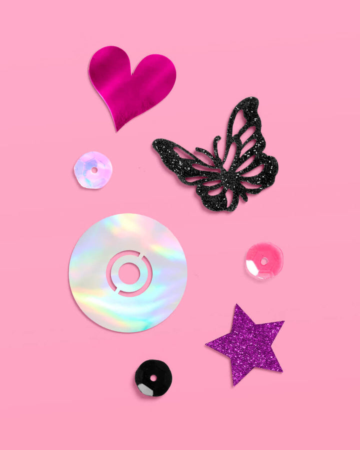 Y2K foil confetti pieces: a pink heart, black butterfly, iridescent CD, purple star, and black dots
