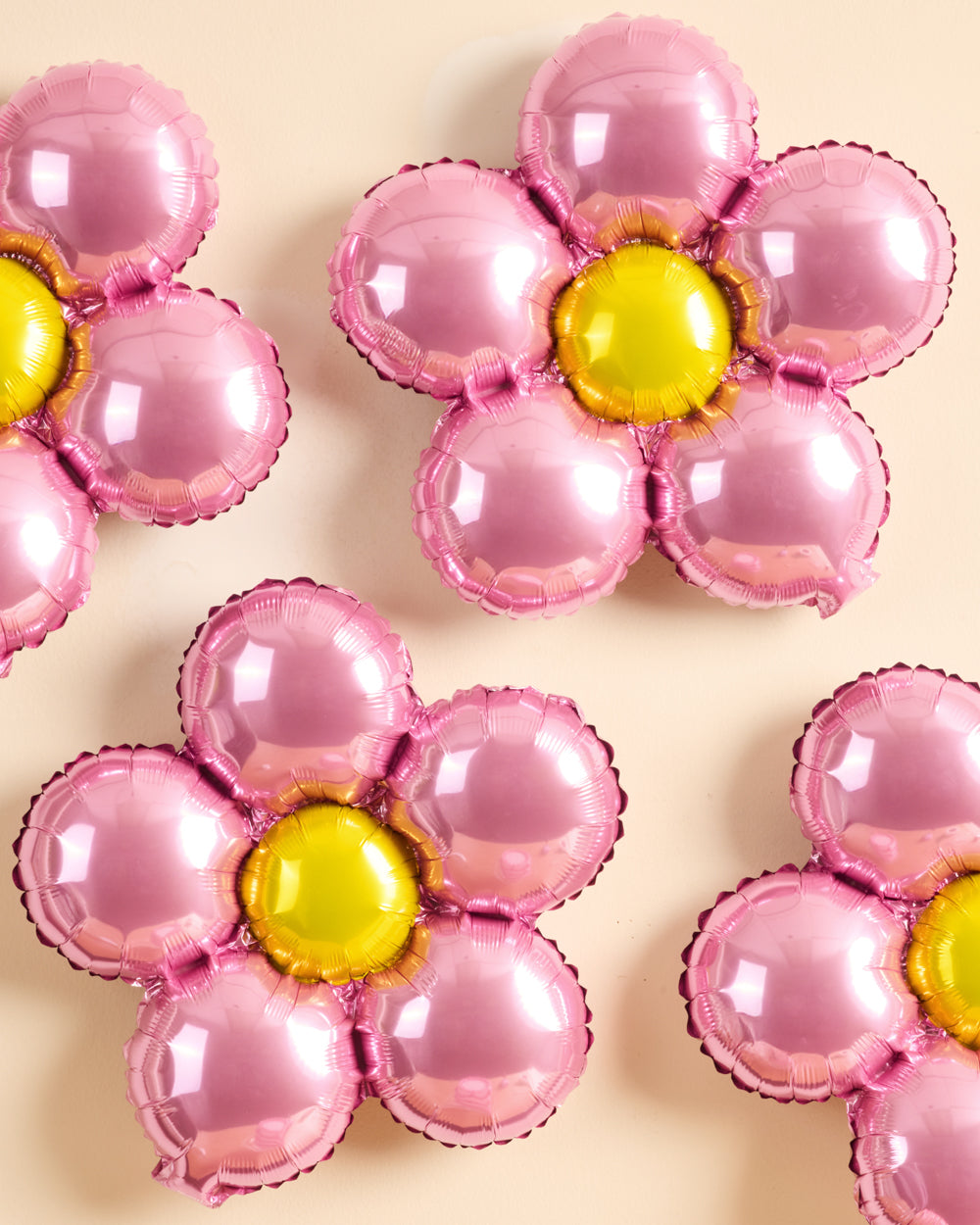 Flower foil balloons styled as a party backdrop