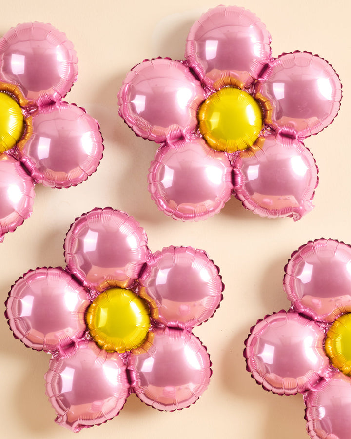 Flower foil balloons styled as a party backdrop