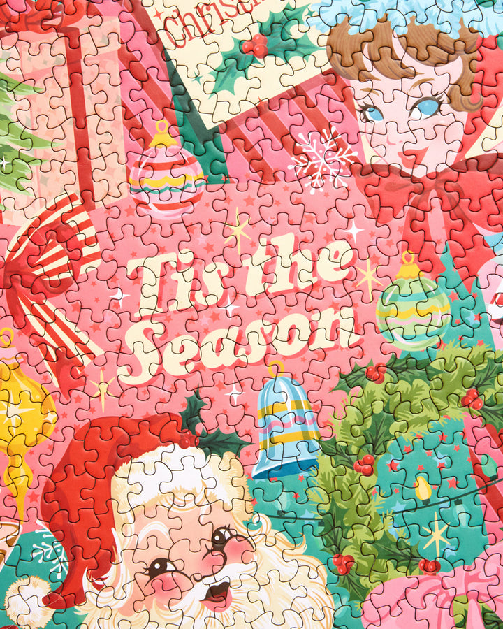 Close-up of Pinkmas puzzle pieces showing Santa, a wreath, ornaments, and the words Tis the Season.