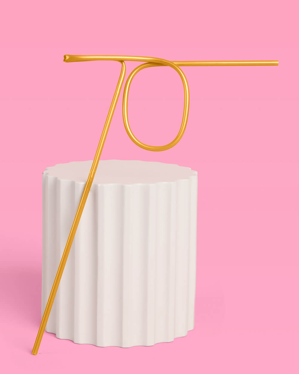 Gold 70 straw in a champagne flute on a pink background