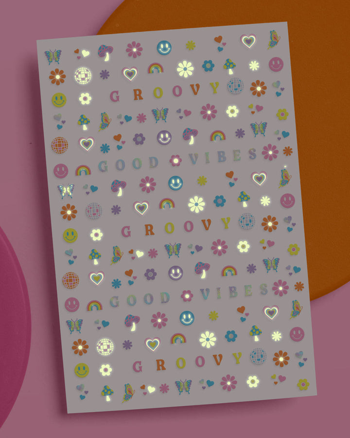 Groovy nail sticker sheet with smiley faces, rainbows, butterflies, daisies, and GOOD VIBES lettering