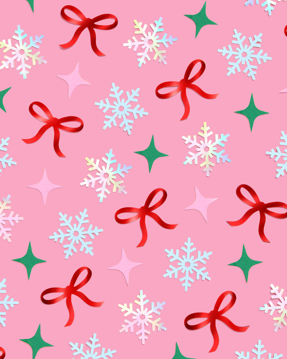 Christmas-themed pattern confetti with snowflakes, bows, and stars on a pink background