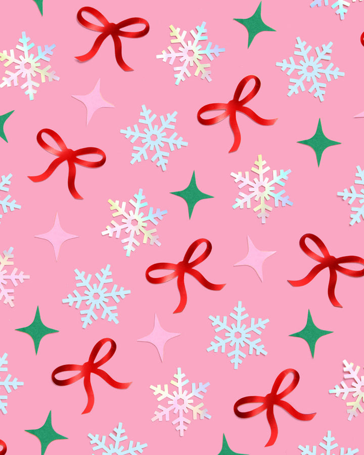 Christmas-themed pattern confetti with snowflakes, bows, and stars on a pink background