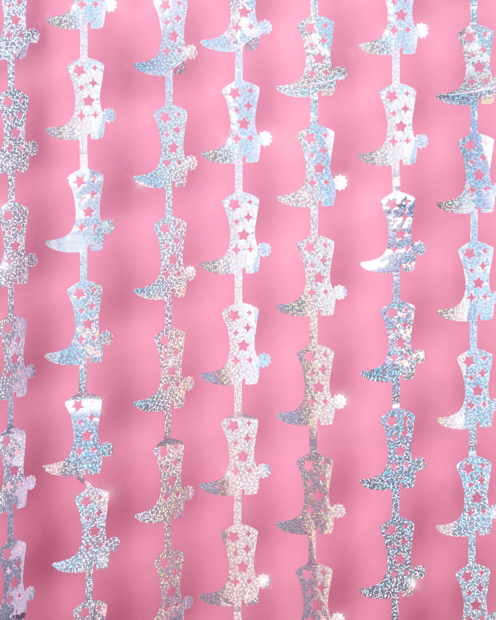 Two cowgirl boot foil curtain panels hung side by side as a bachelorette photo booth backdrop