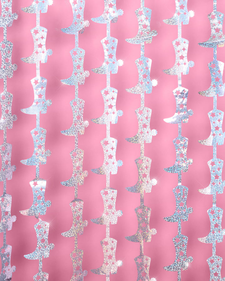Two cowgirl boot foil curtain panels hung side by side as a bachelorette photo booth backdrop