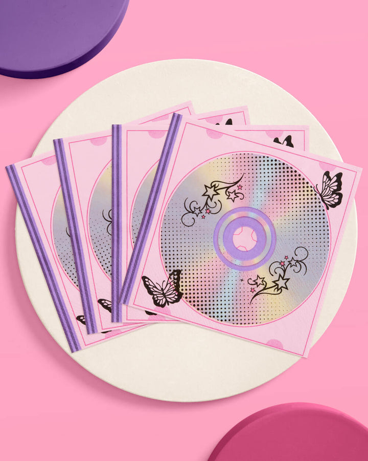 Y2K iridescent CD cocktail napkins fanned on a cream plate