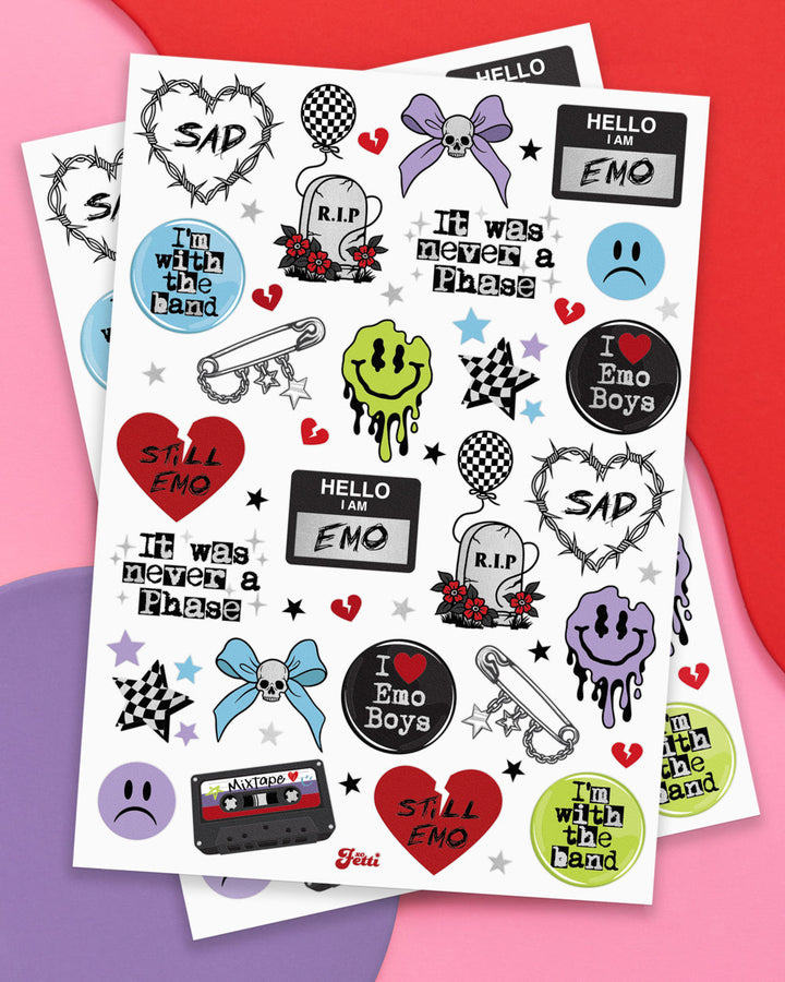 Two sheets of emo temporary tattoos with hearts, cassettes, safety pins, bows, and sad faces