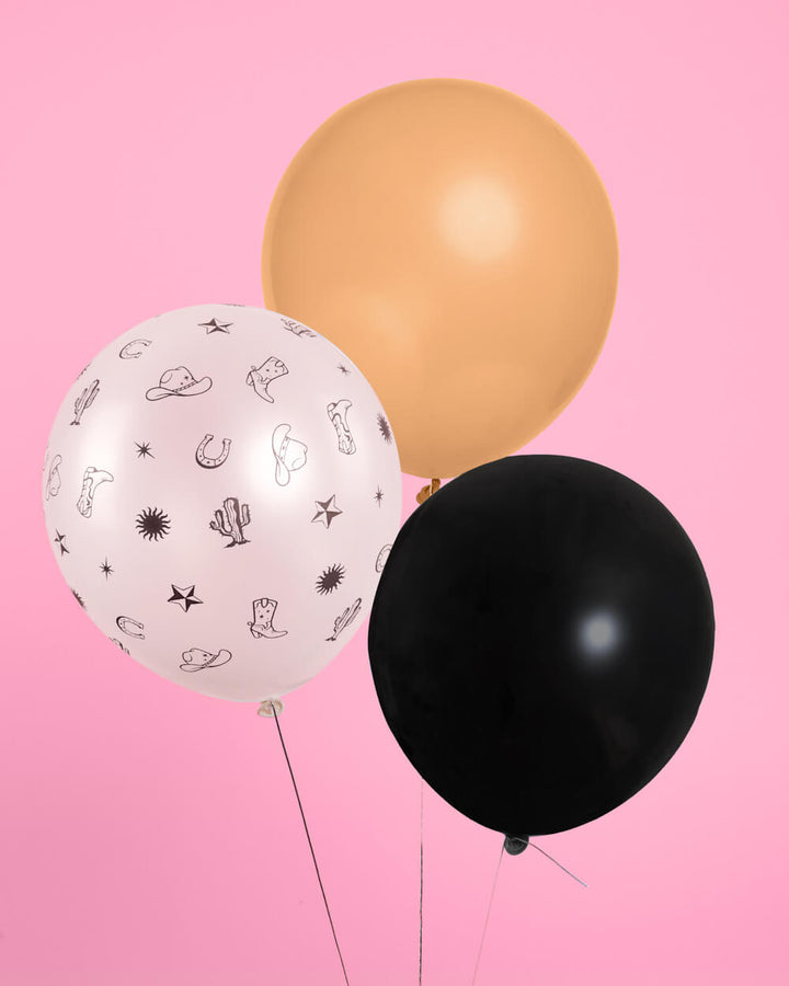 Cowgirl balloons styled as a party backdrop