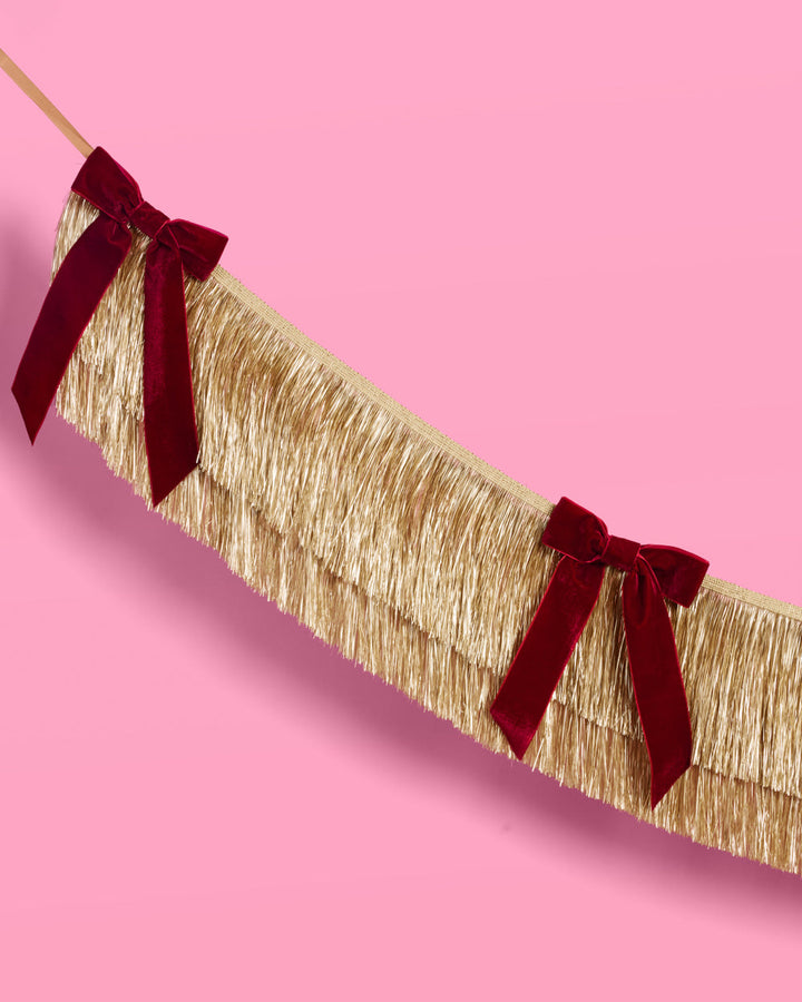 Gold Fringe Backdrop with Burgundy Velvet Bows