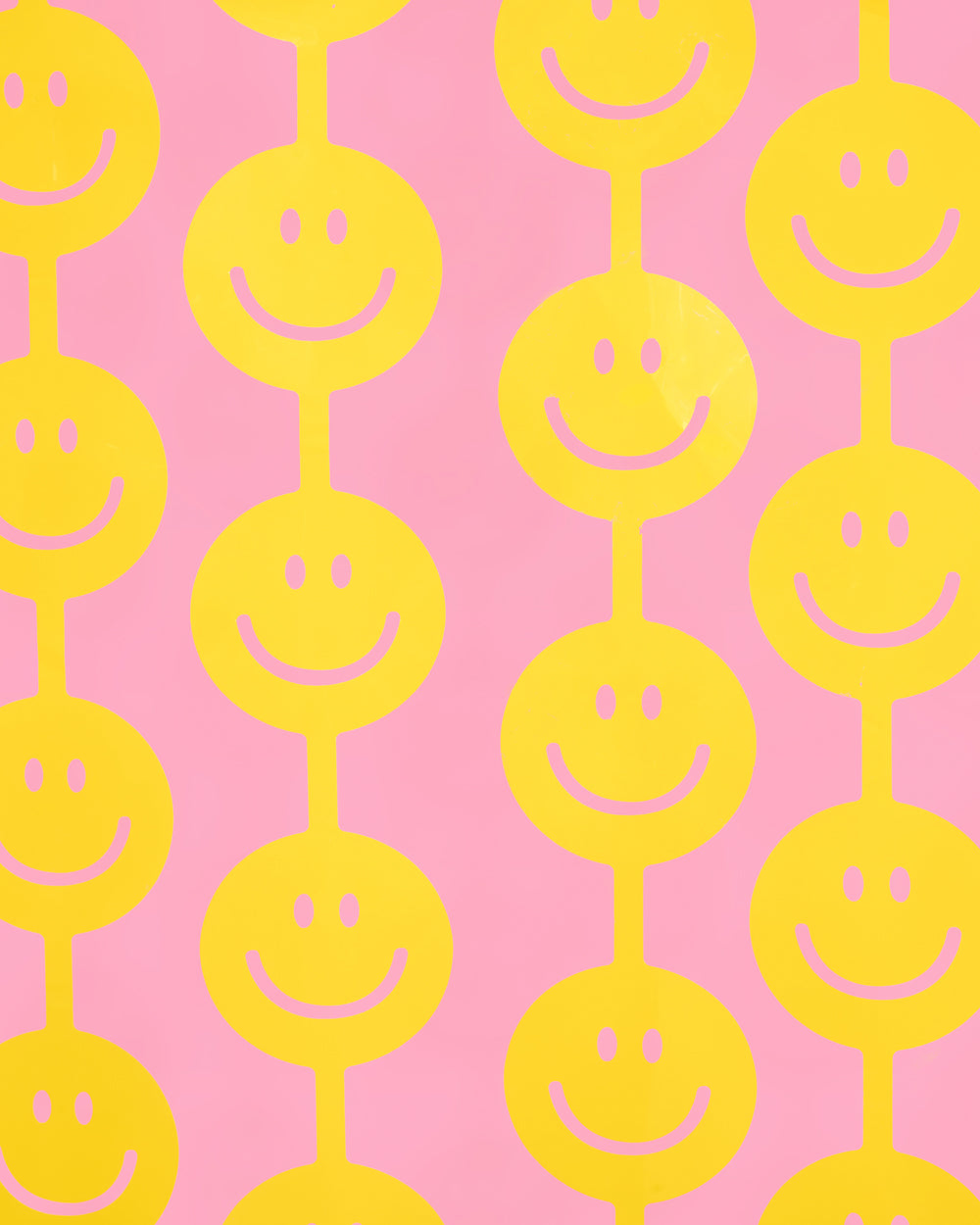 Close-up of large yellow smiley faces on a smiley curtain backdrop