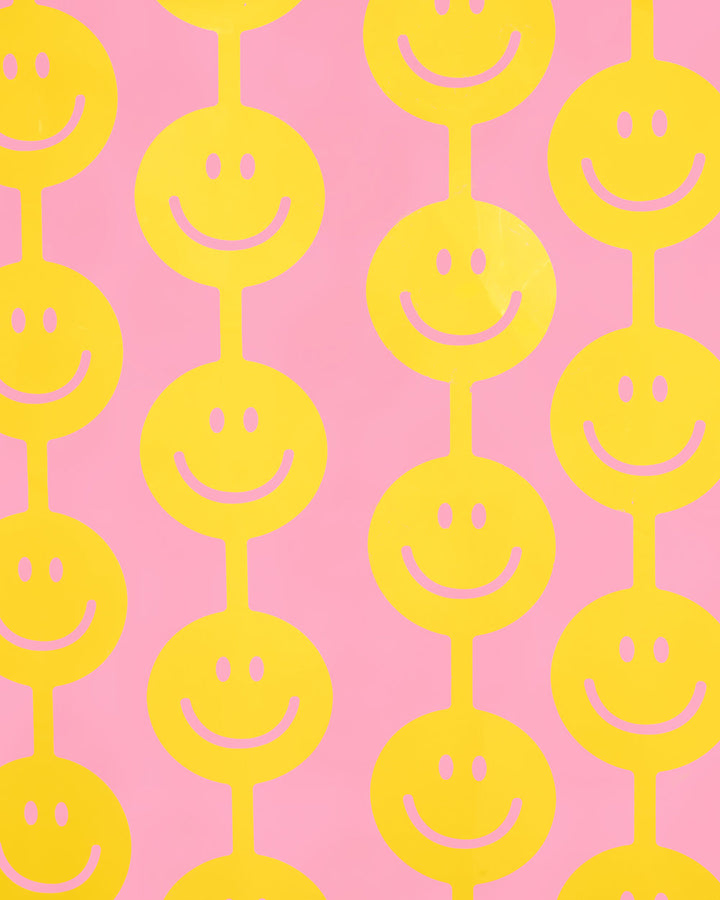Close-up of large yellow smiley faces on a smiley curtain backdrop