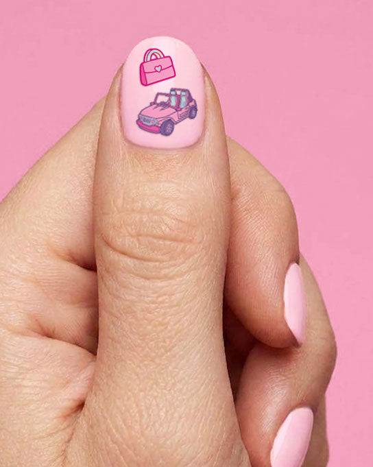 Thumb wearing a pink handbag and a pink convertible car nail sticker
