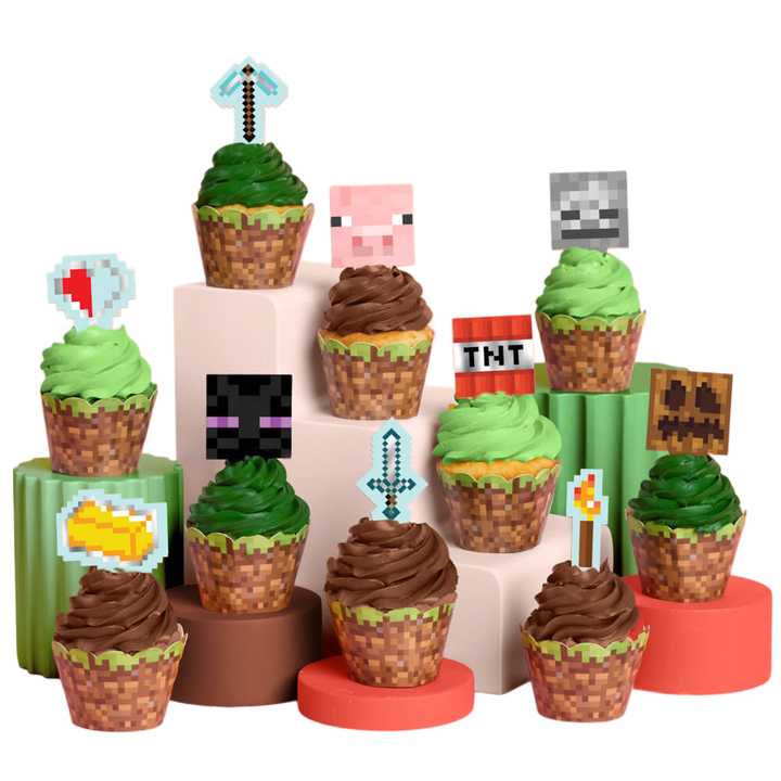 Minecraft cupcake kit with pixel toppers including a pickaxe, TNT, and creeper plus grass-block cupcake wrappers for a gaming birthday party