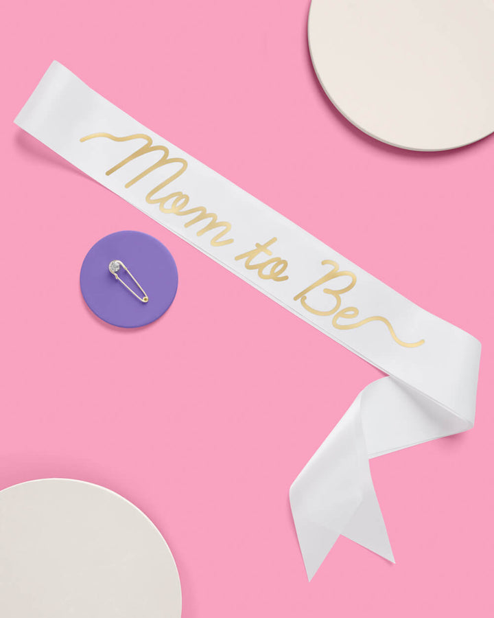 White satin baby shower sash lettered for the mom to be