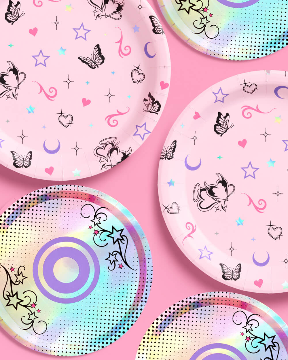 Pink butterfly dinner plates and iridescent CD dessert plates overlapping on a pink table