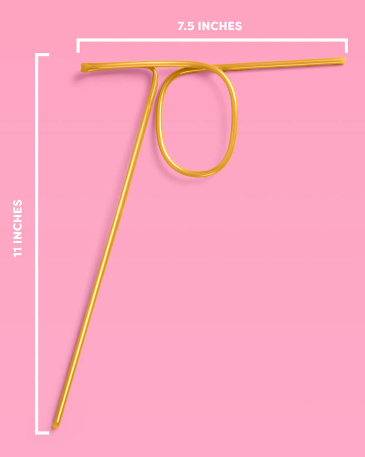 Gold reusable 70 birthday straw on a pink background