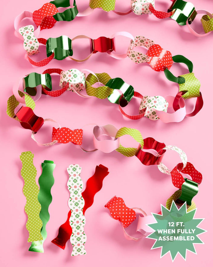 Coiled paper chain garland beside loose printed and metallic strips