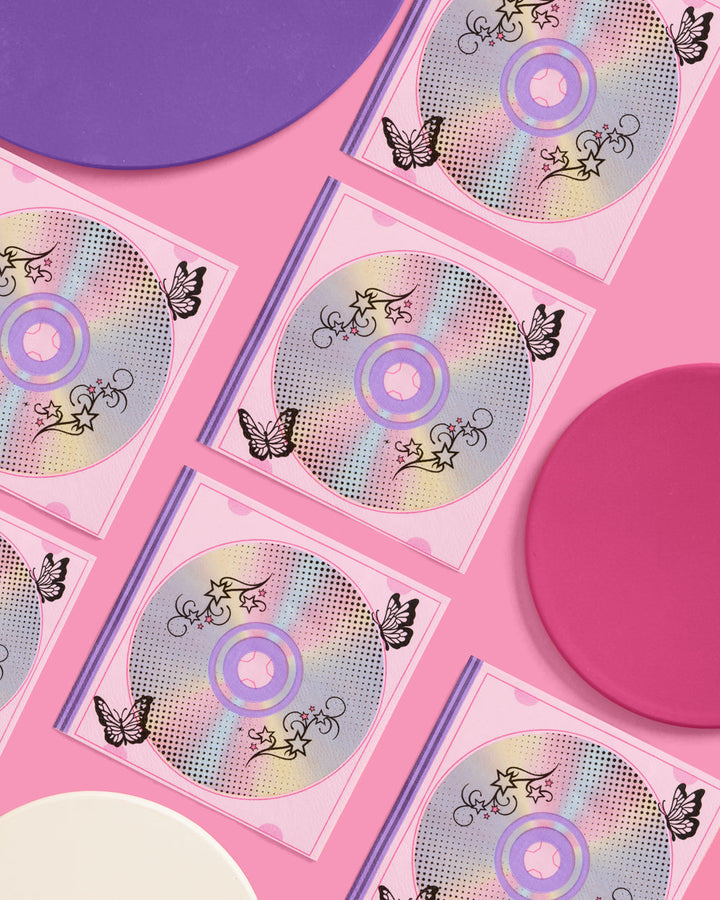 Rows of Y2K iridescent CD print napkins arranged on a pink and purple backdrop