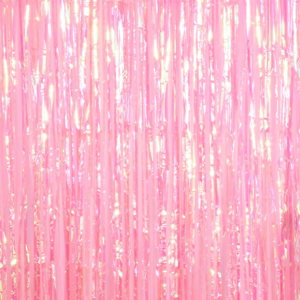 Plain light pink iridescent foil fringe curtain hung on its own as a party backdrop
