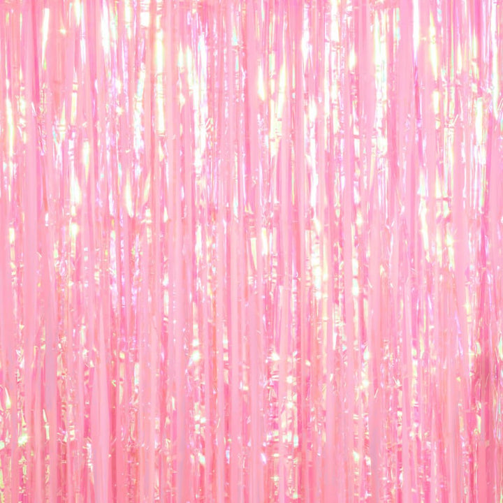 Plain light pink iridescent foil fringe curtain hung on its own as a party backdrop