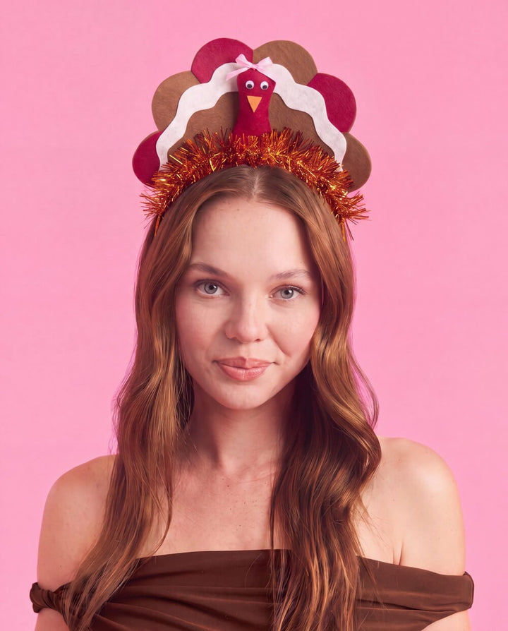 Woman wearing the turkey headband, showing the orange tinsel wrapped band